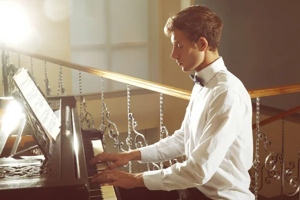 Young man playing piano
