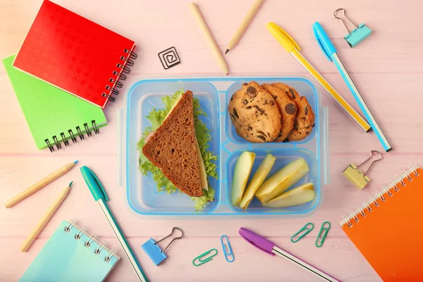 Lunchbox with dinner and stationery — Stock Photo, Image