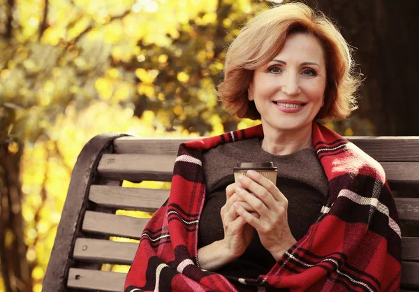 Mujer con taza de café en el parque de otoño — Foto de Stock