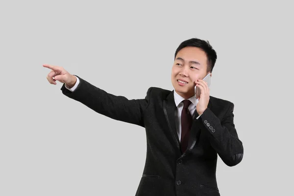Asian man pointing at something — Stock Photo, Image