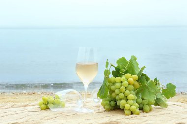 Glasses of wine and fresh grapes clipart