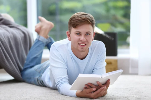 Young handsome man reading book — Stock Photo, Image