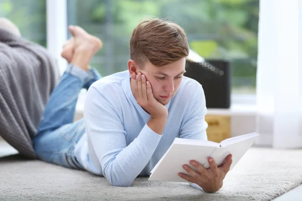 Young handsome man reading book — Stock Photo, Image