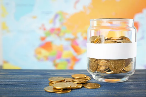 Jar with money on world map