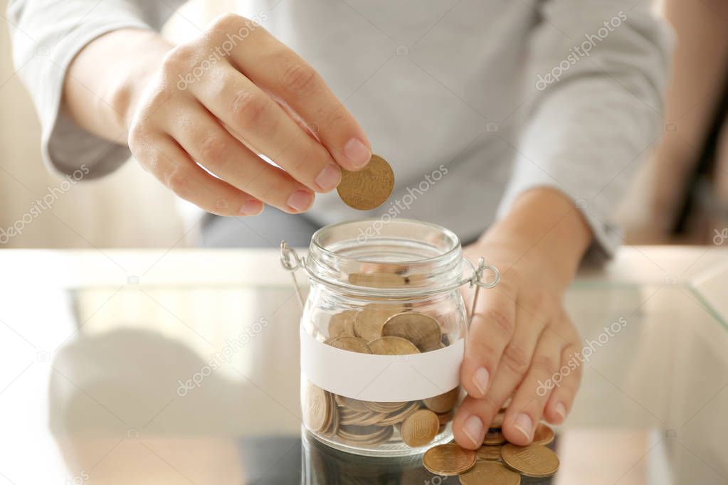 Female hand putting money 