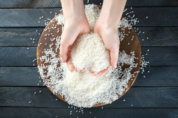 Female hands full of rice — Stock Photo, Image