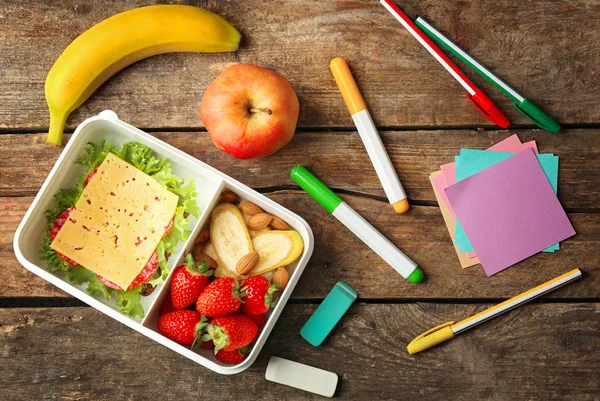 Lunch box with food and stationery — Stock Photo, Image