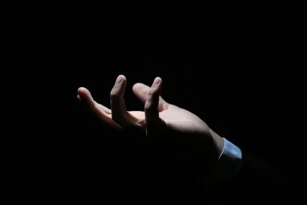Hand of businessman on black — Stock Photo, Image