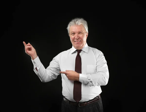 Senior businessman on black — Stock Photo, Image