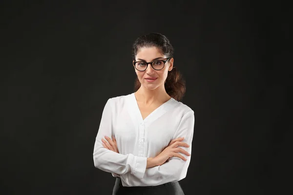 Young businesswoman on black — Stock Photo, Image