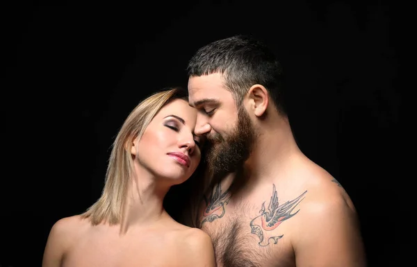 Portrait of romantic tattooed couple