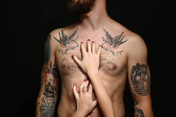 Tattooed Man Met Een Vrouw Handen Lichaam Zwarte Achtergrond — Stockfoto