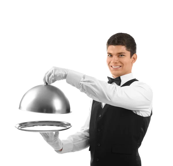 Manliga servitör holding cloche och fack Stockbild