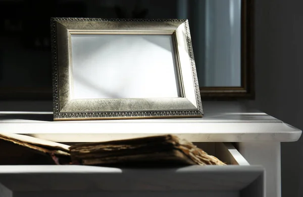 Vintage frame on wooden chest of drawers — Stock Photo, Image