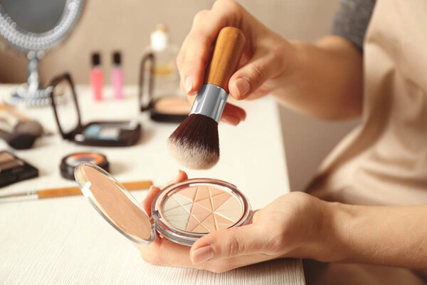 Female hands holding face powder