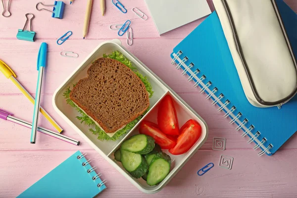 Lunchbox with dinner and stationery — Stock Photo, Image