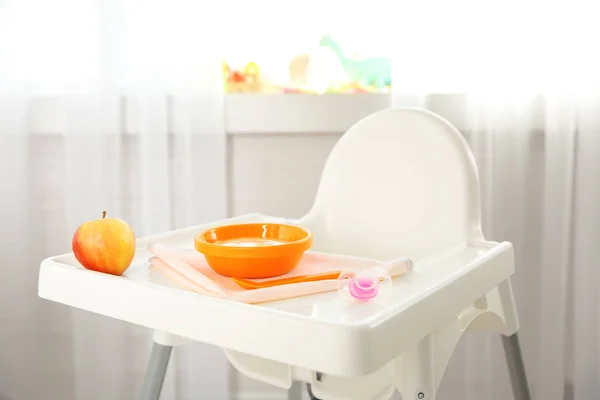 Highchair with healthy baby food — Stock Photo, Image