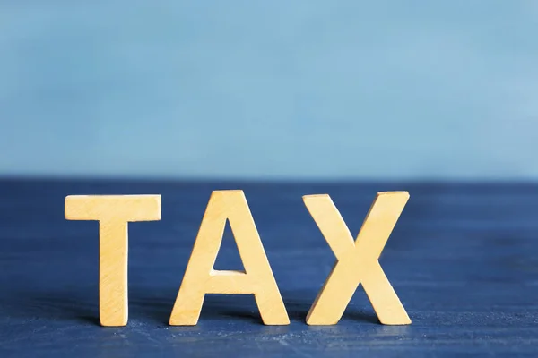 Word TAX on blue — Stock Photo, Image