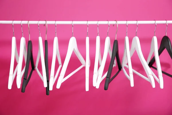 Modern hangers on pink background — Stock Photo, Image