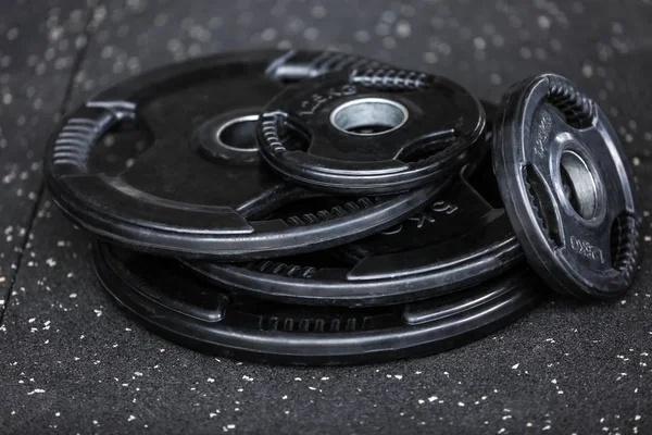 Weight plates on floor in gym — Stock Photo, Image