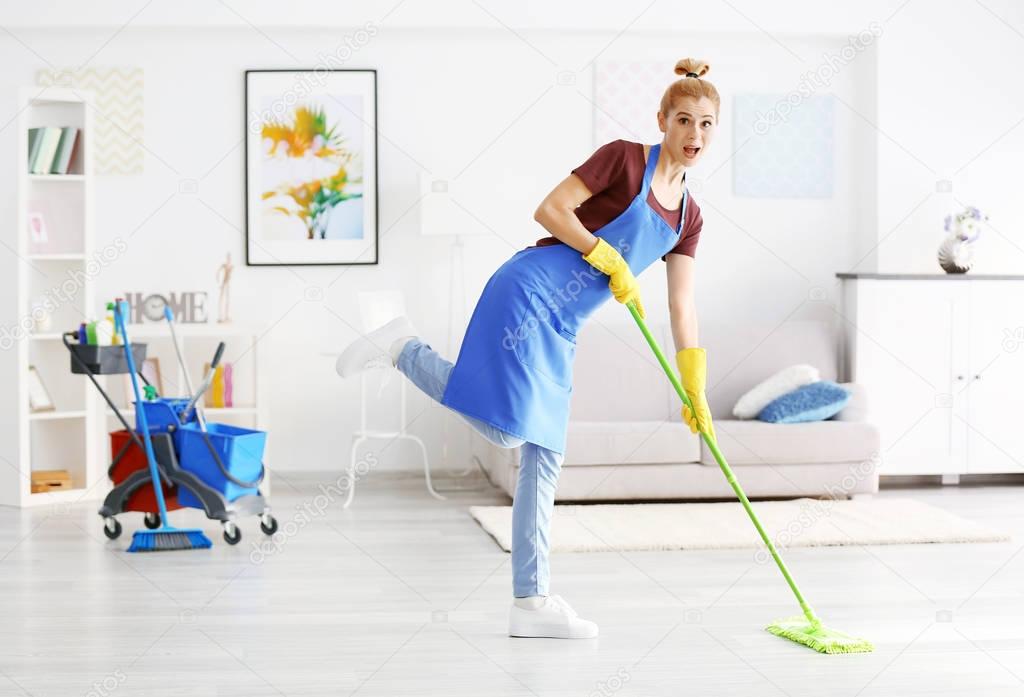 woman moping floor in living room