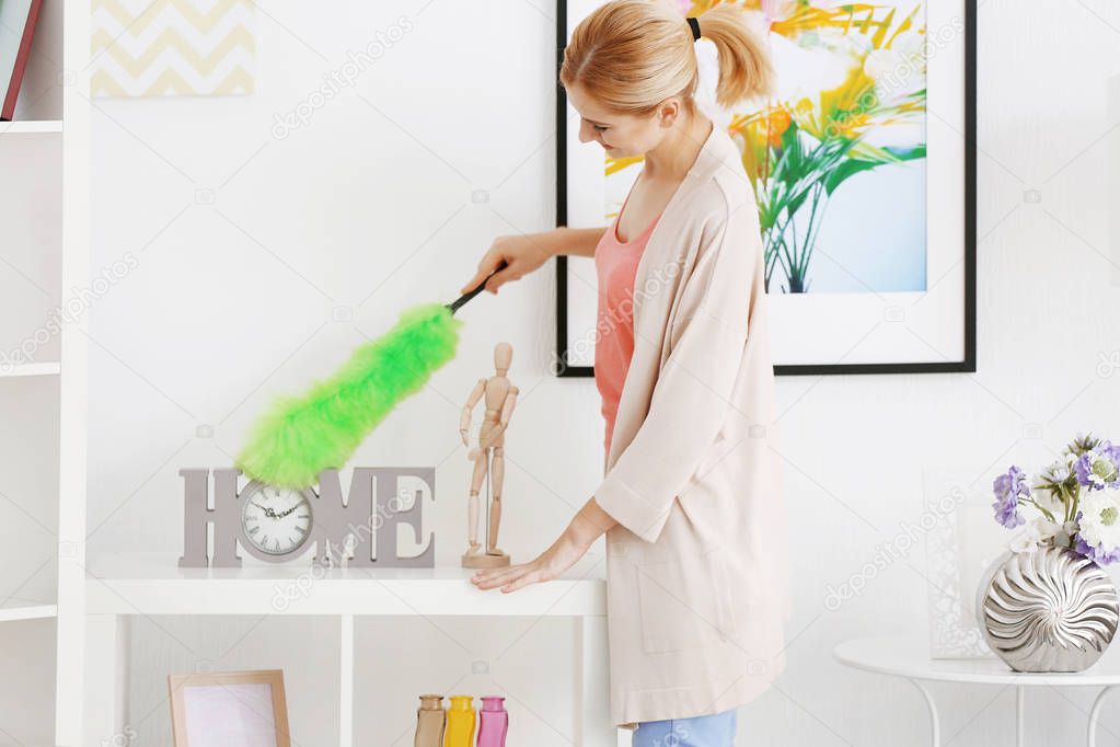 woman cleaning house from dust