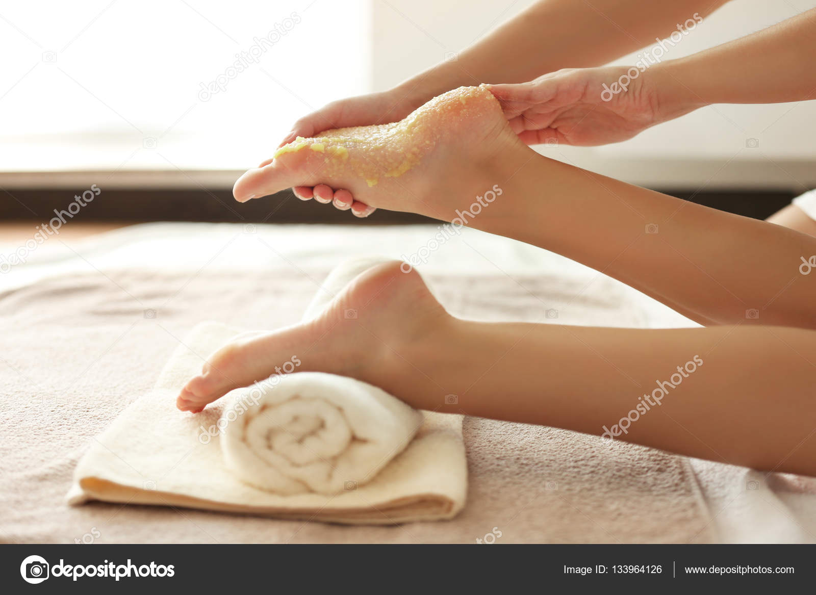 Hands massaging female feet with scrub — Stock Photo © belchonock