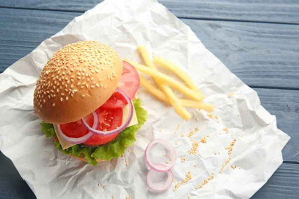 Delicious cheeseburger on paper — Stock Photo, Image