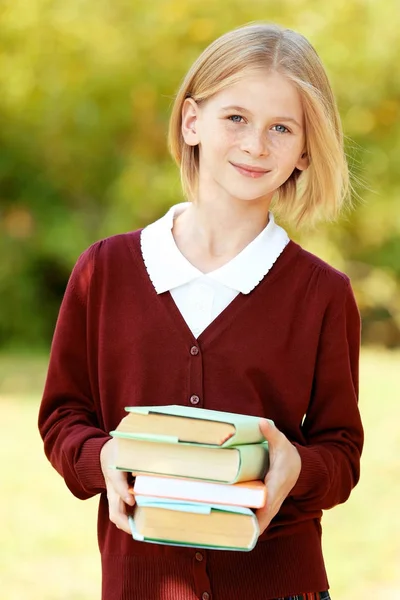 Schoolgirl with books outdoors — Stock Photo, Image