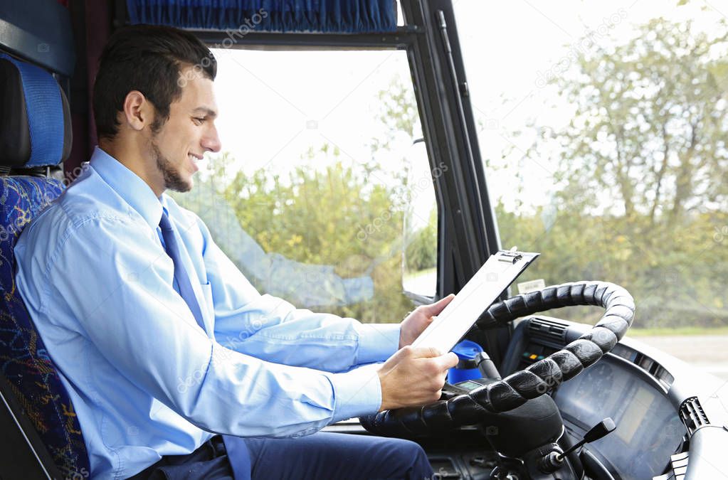 driver with clipboard in bus