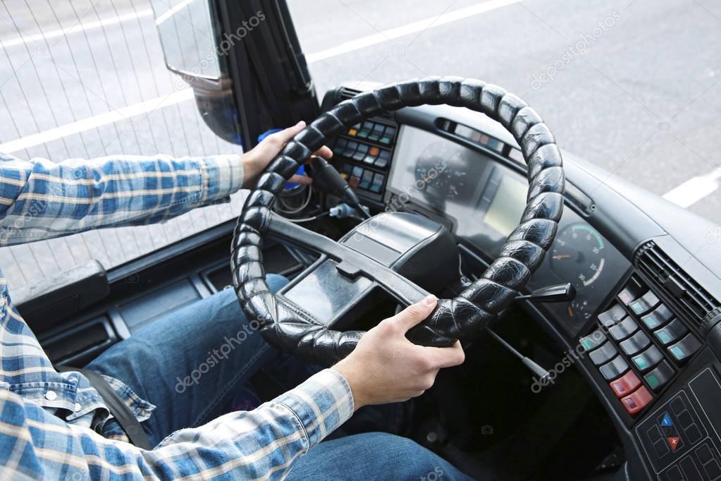 Hands of driver on steering wheel