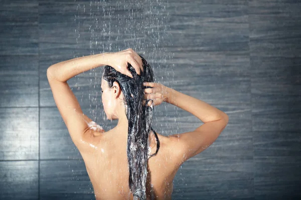 woman washing hair in shower