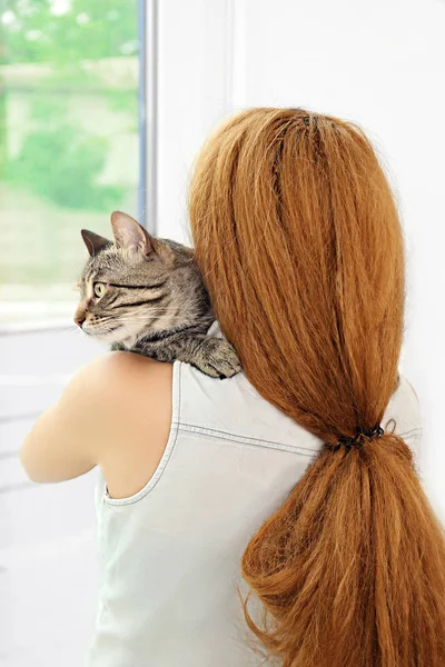 Young woman with tabby cat