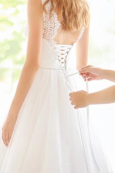 Bridesmaid tying bow — Stock Photo, Image