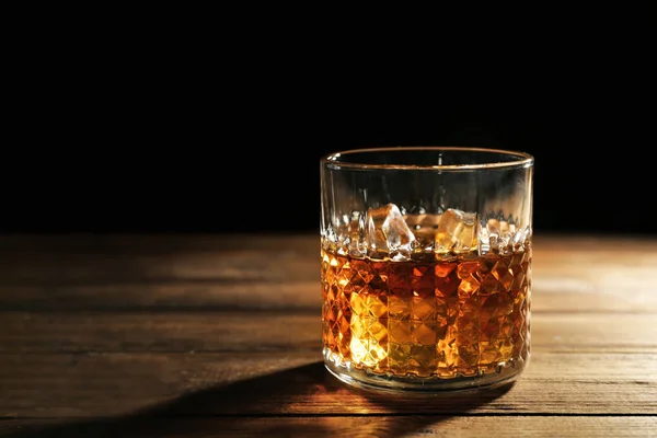 Glass of whisky on wooden table — Stock Photo, Image