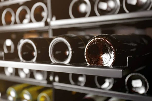 Shelving with different wine bottles — Stock Photo, Image