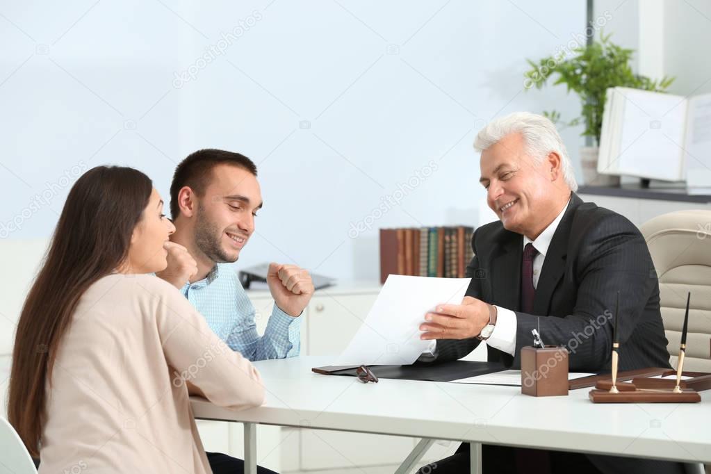 Young couple with notary at office