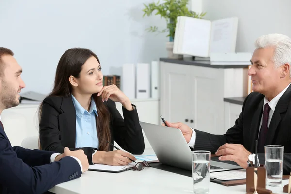 Young couple with notary at office — Stock Photo, Image