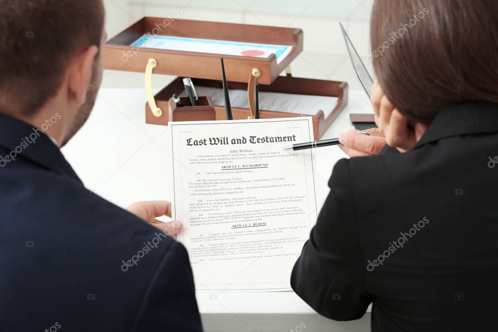 Young couple with notary at office