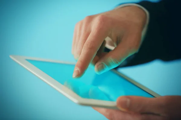 finger touching tablet screen