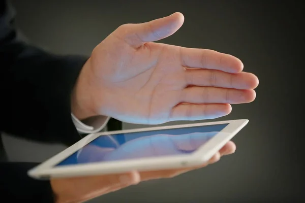 finger touching tablet screen