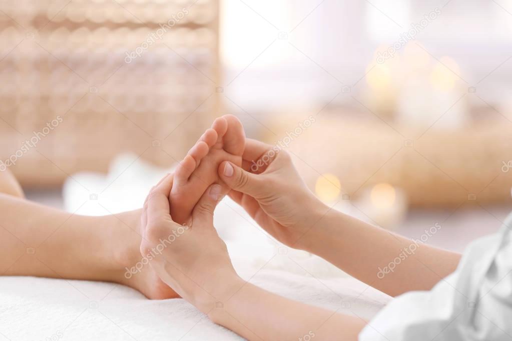 Foot massage in spa salon