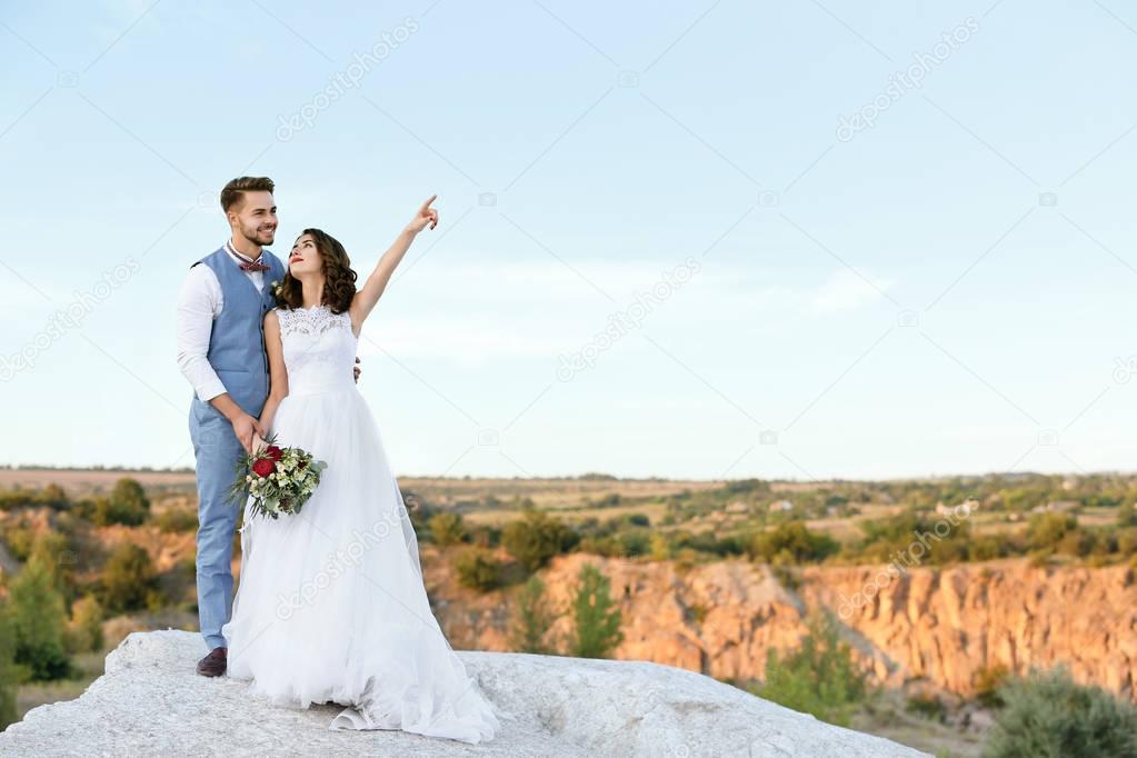 Bride and groom over beautiful landscape