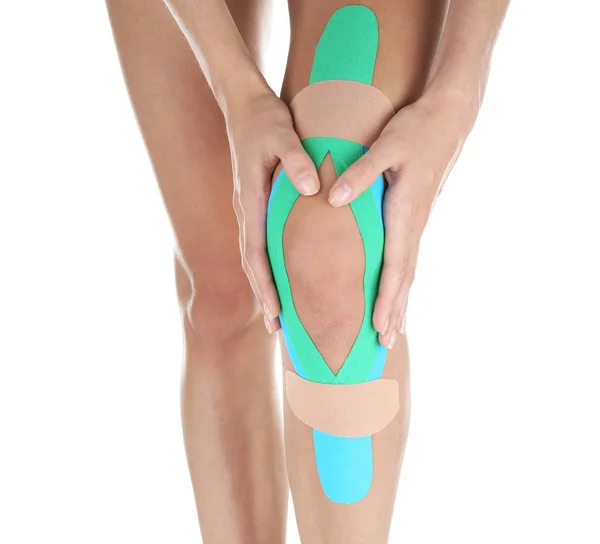 Female knee with physio tape — Stock Photo, Image