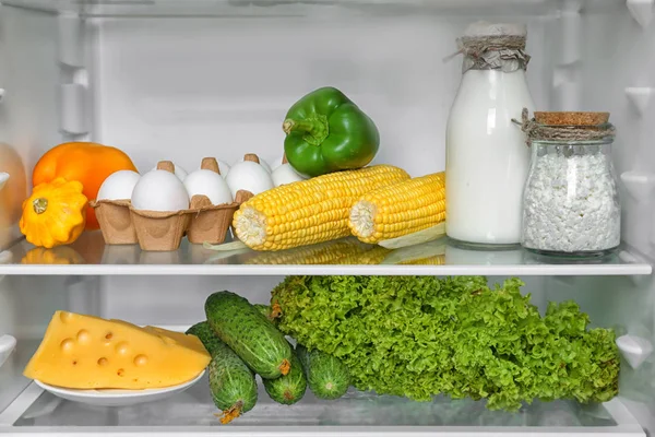 Open refrigerator full of vegetables — Stock Photo, Image