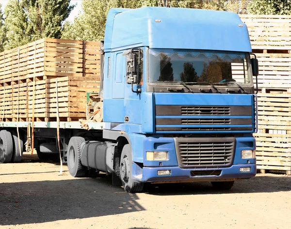 Truck carrying empty wooden crates for harvesting