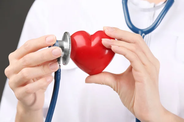 Doctor with stethoscope holding heart — Stock Photo, Image