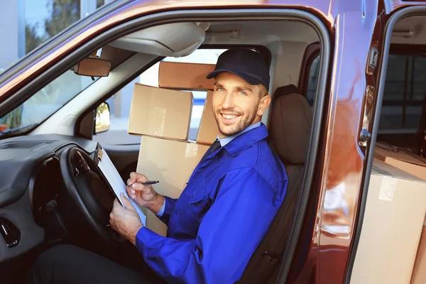 Delivery man checking list — Stock Photo, Image