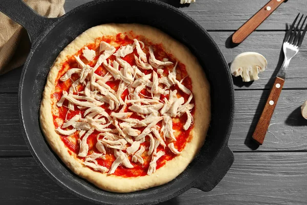 Unbaked pizza in pan