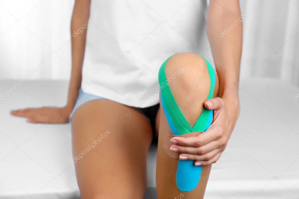 Female knee with physio tape